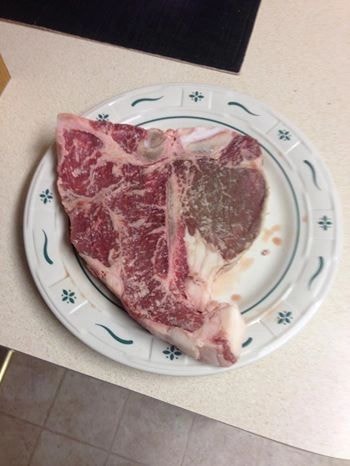 Dinner plate sized T-bone steak showing great marbling